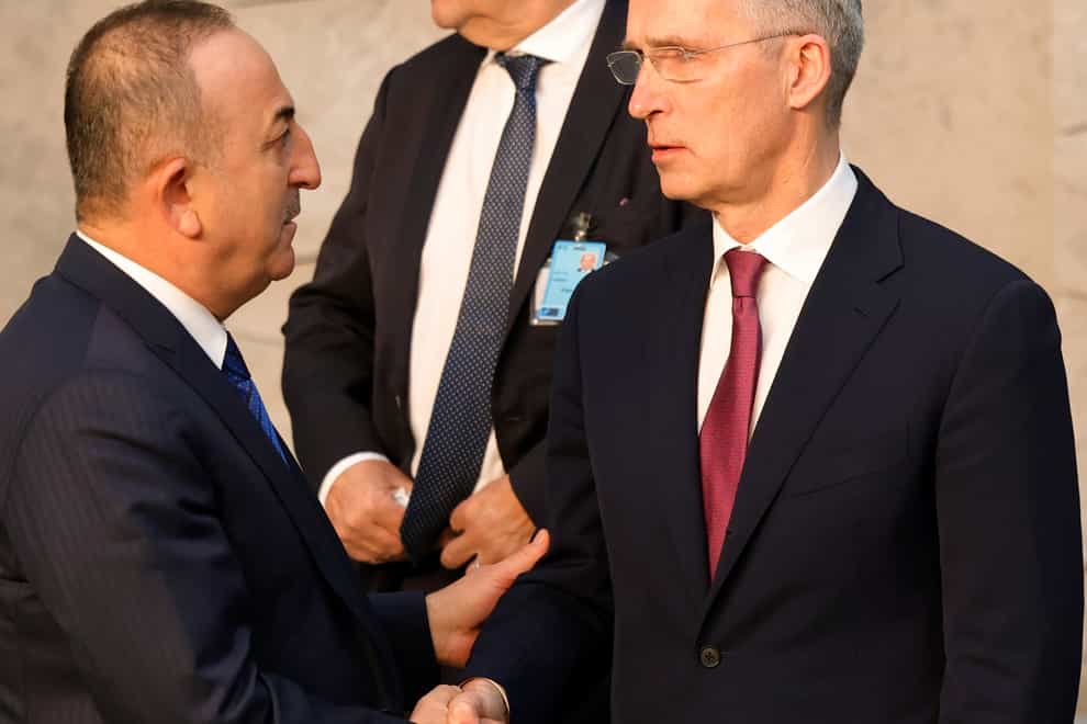 Turkish Foreign Minister Mevlut Cavusoglu, left, speaks with Nato Secretary General Jens Stoltenberg (Olivier Matthys/AP)