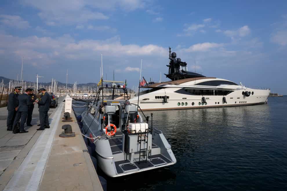 Italian police by the yacht Lady M, owned by Russian oligarch Alexei Mordashov (Antonio Calanni/AP)