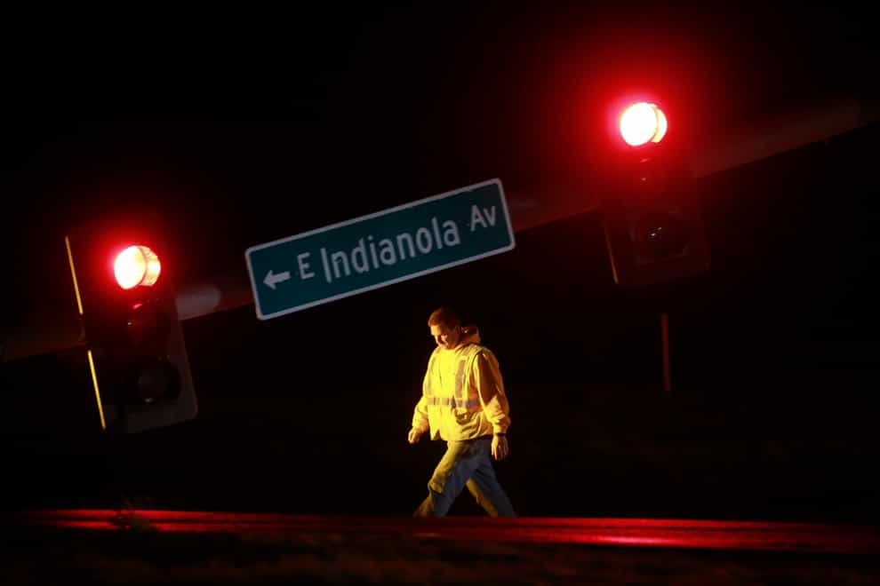 A utility worker tends to a downed traffic light in Des Moines, Iowa (Bryon Houlgrave/The Des Moines Register/AP)