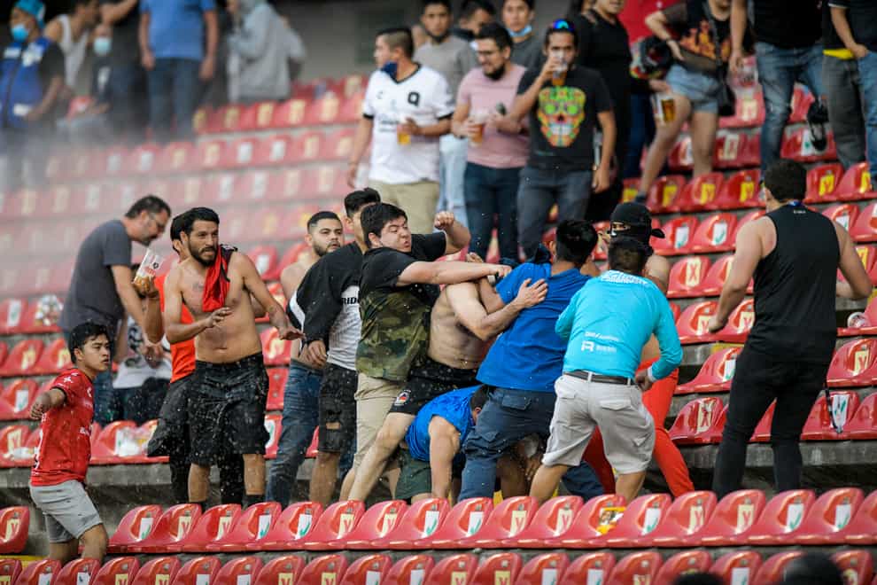 Fans clash during a Liga MX match between Queretaro and Atlas (Sergio Gonzalez/AP)