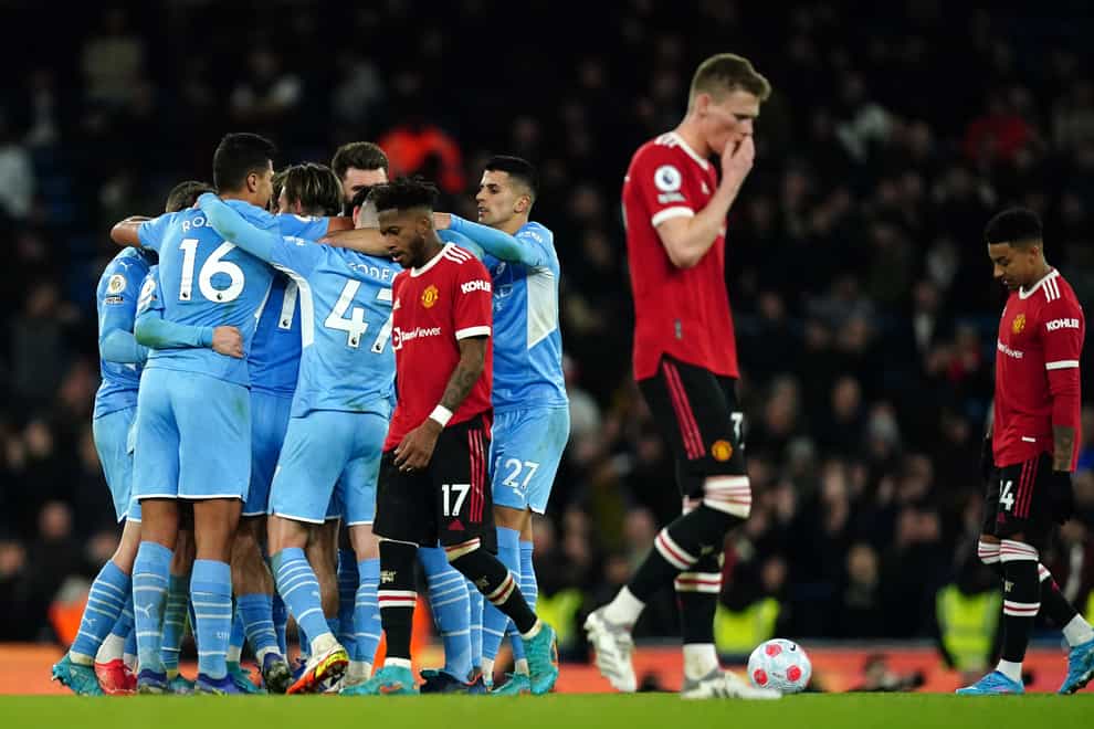 United’s despair is apparent as Manchester City celebrate their fourth goal (Martin Rickett/PA)
