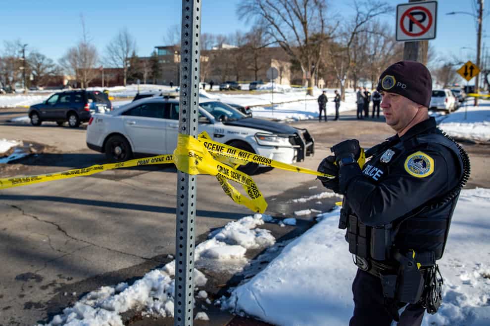 Police investigate a shooting outside of East High School in in Des Moines, Iowa, on Monday, March 7, 2022. (Zach Boyden-Holmes/The Des Moines Register via AP)