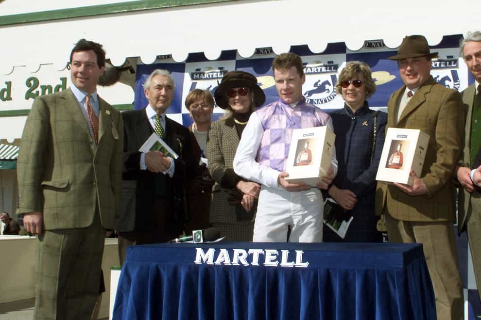 Mick Fitzgerald with Sir Robert Ogden (second left) at Aintree (PA)