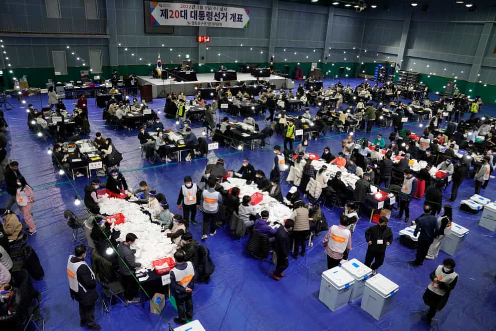 National Election Commission officials sort out ballots for counting (Lee Jin-man/AP)