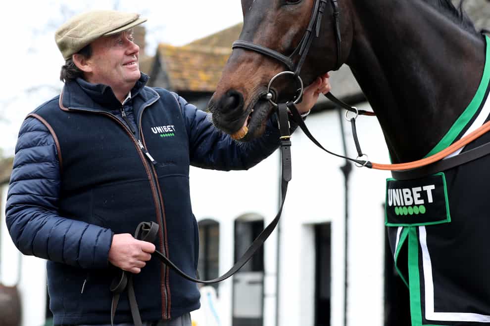 Nicky Henderson poses for a photo with Altior (Bradley Collyer/PA)