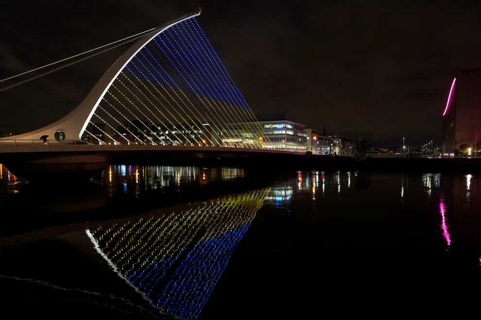 The Samuel Beckett Bridge in Dublin’s city centre displays the colours of the Ukrainian flag as a show of support. Simon Coveney appeared before the Oireachtas Foreign Affairs Committee on Thursday (Brian Lawless/PA)