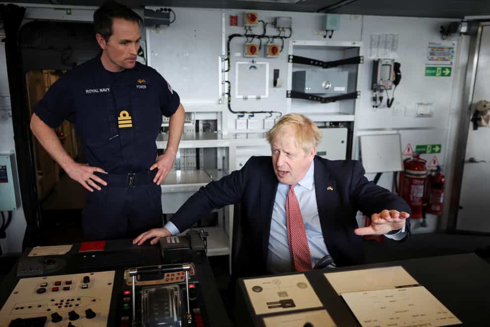 Boris Johnson sits on the bridge of HMS Dauntless during a visit to the Cammell Laird shipyard in Merseyside (Phil Noble/PA)