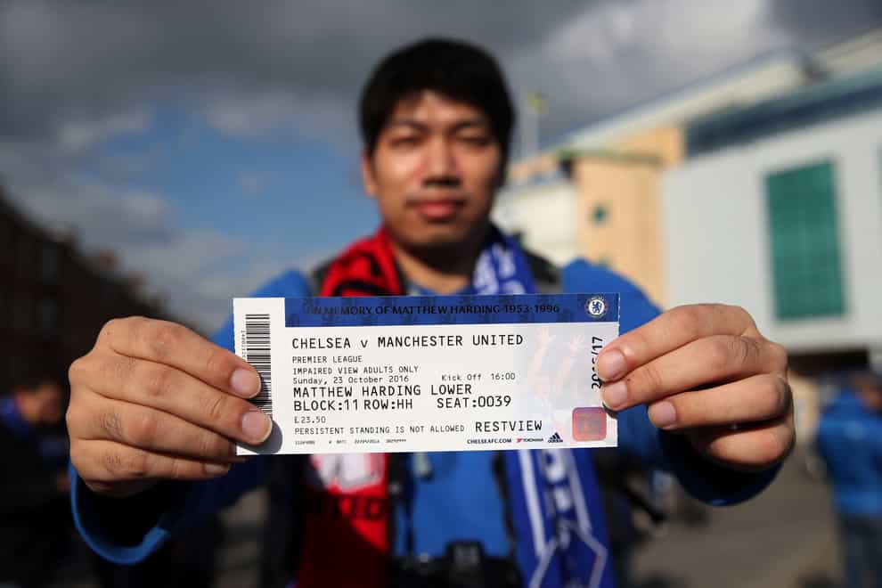 A Chelsea fan shows one of the last tickets to be sold before the embargo on ticket sales came into force (Nick Potts/PA)