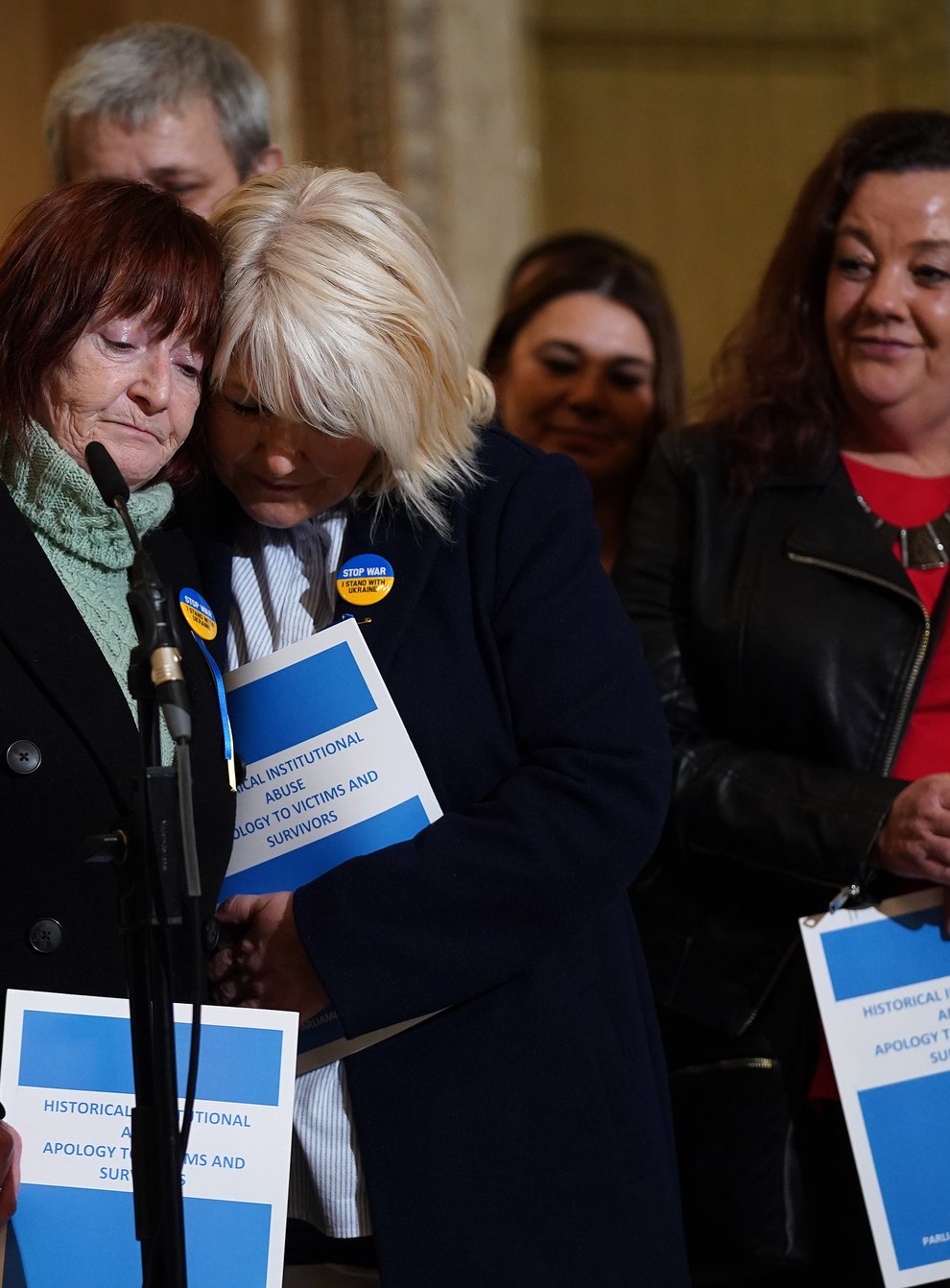 Kate Walmsley (left) and Margaret McGuckin (centre) react to the long-awaited public apology to victims of historical institutional abuse (Brian Lawless/PA)