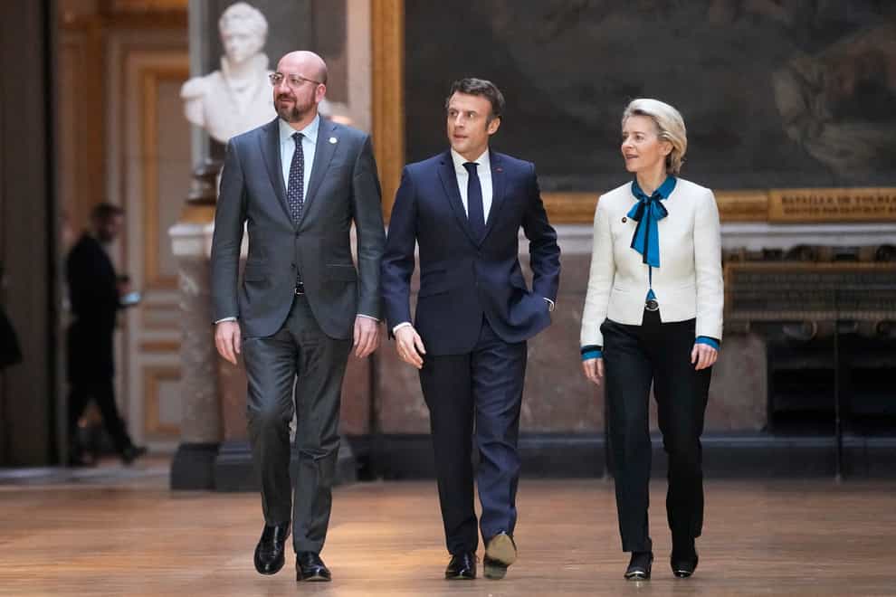 President of the European Council Charles Michel, left, French President Emmanuel Macron and European Commission president Ursula von der Leyen arrive for a press conference after the EU summit at the Chateau de Versailles (Michel Euler/AP)