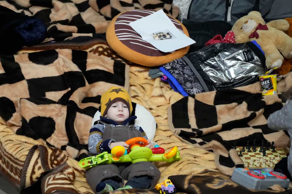 A boy holds a toy as he rests in a centre for Ukrainian refugees in Warsaw, Poland (Czarek Sokolowski/AP)