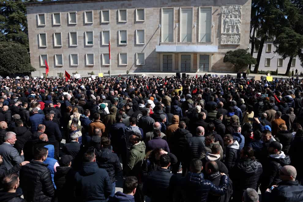 Protesters gather outside Prime Minister’s office during an anti-government rally in Tirana, Albania, Saturday, March 12, 2022. Thousands of Albanians are holding on Saturday a protest in the capital Tirana against recent price hikes that authorities blame on the war in Ukraine. (AP Photo/Franc Zhurda)