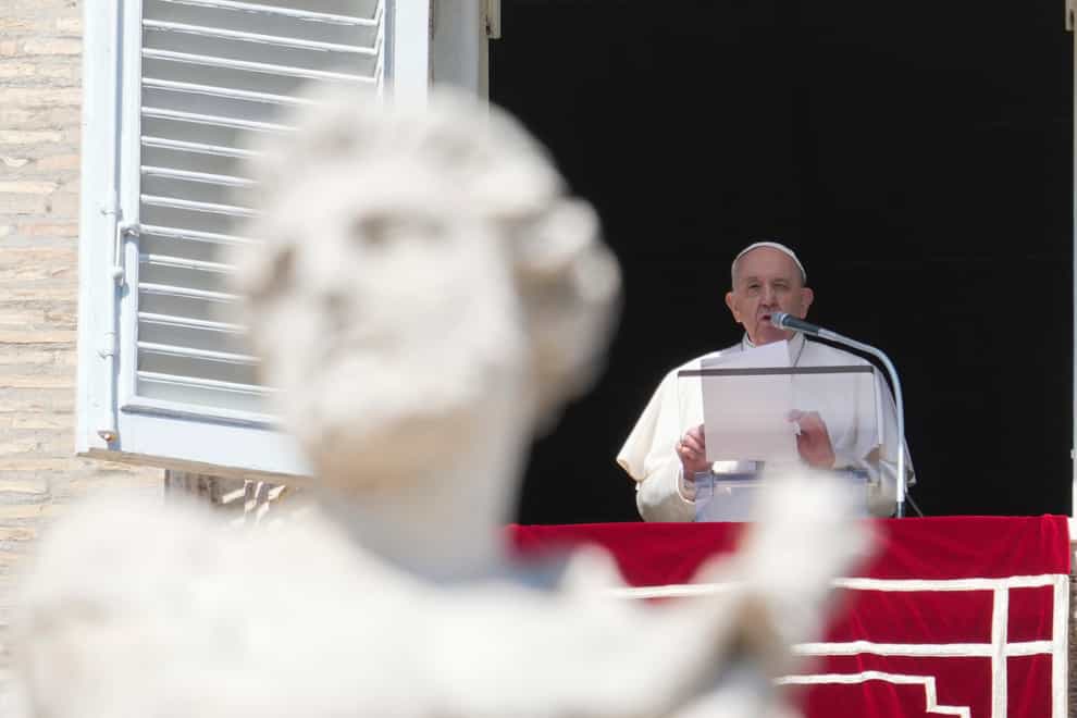 Pope Francis waves from the window of his studio overlooking St Peter’s Square (Gregorio Borgia/AP)