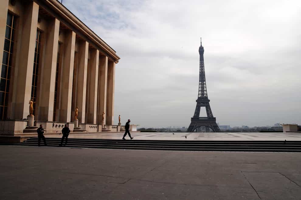 Police officers patrol on the empty Trocadero square in front of the Eiffel Tower in Paris on March 17 2020 (Francois Mori/AP)