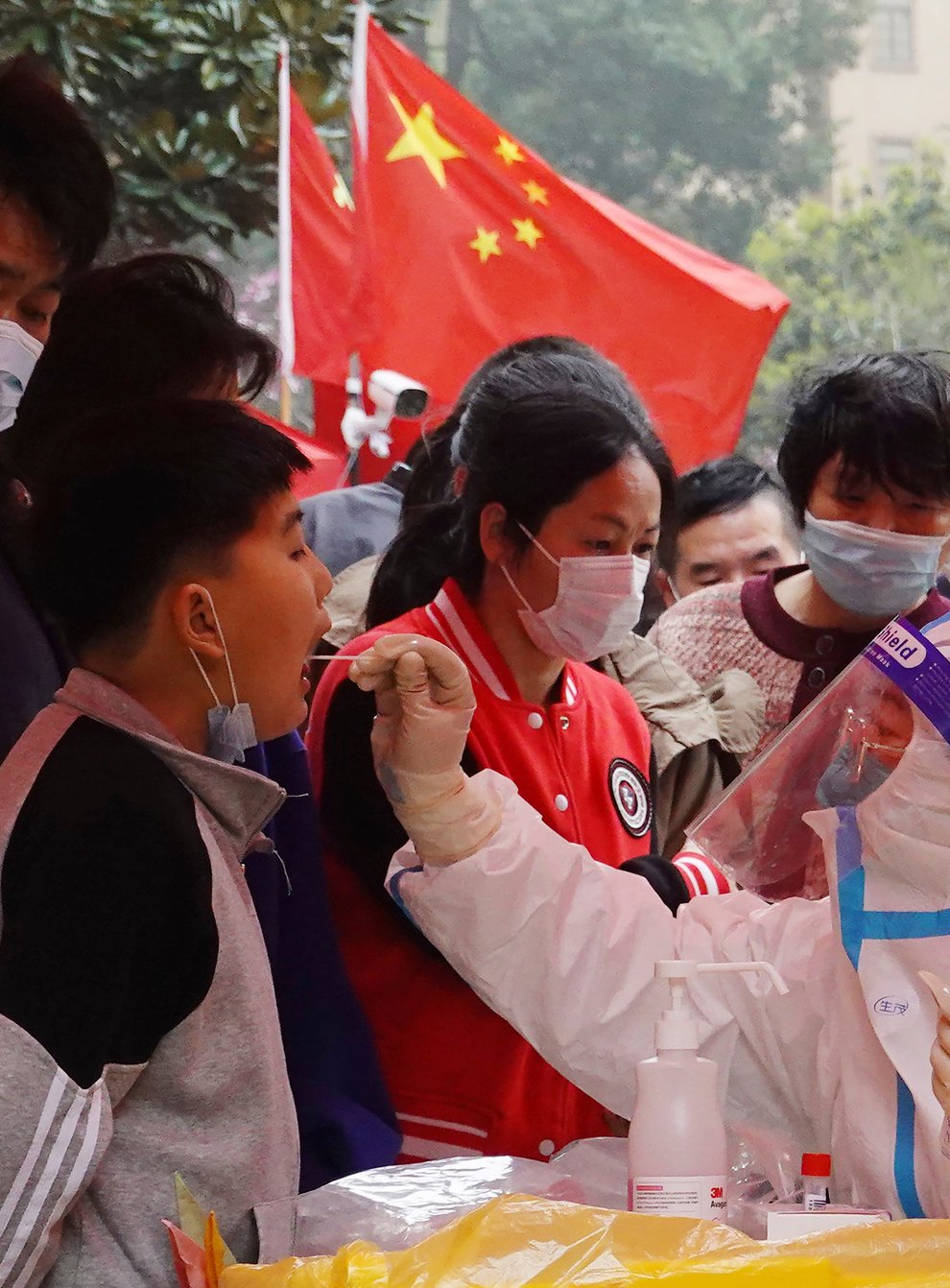 A medical worker takes a swab sample from a child for Covid-19 testing in a community in Changzhou in eastern China’s Jiangsu province (Chinatopix via AP)