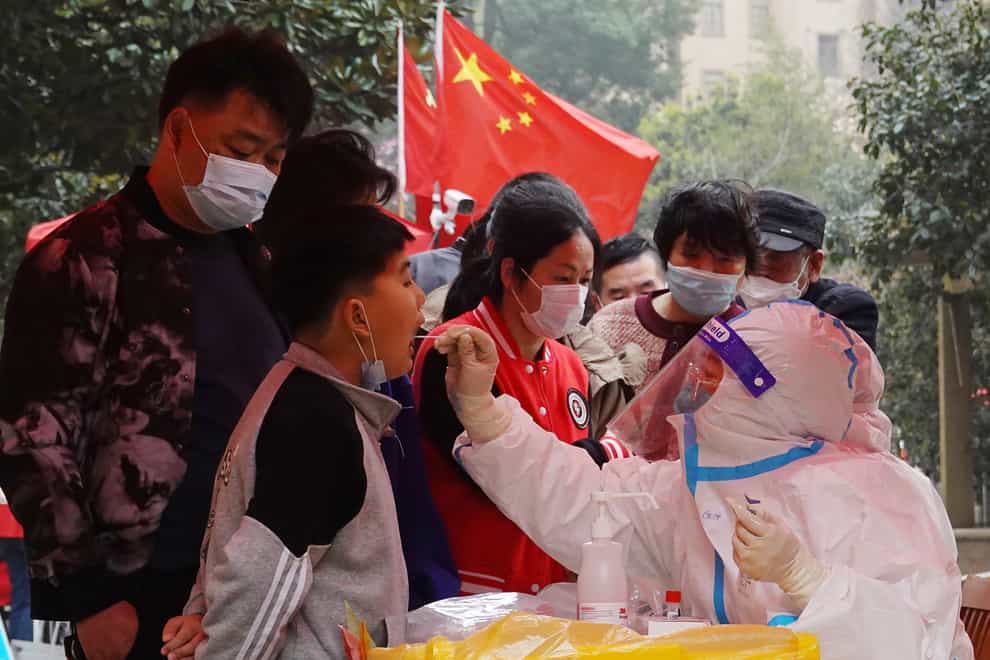 A medical worker takes a swab sample from a child for Covid-19 testing in a community in Changzhou in eastern China’s Jiangsu province (Chinatopix via AP)