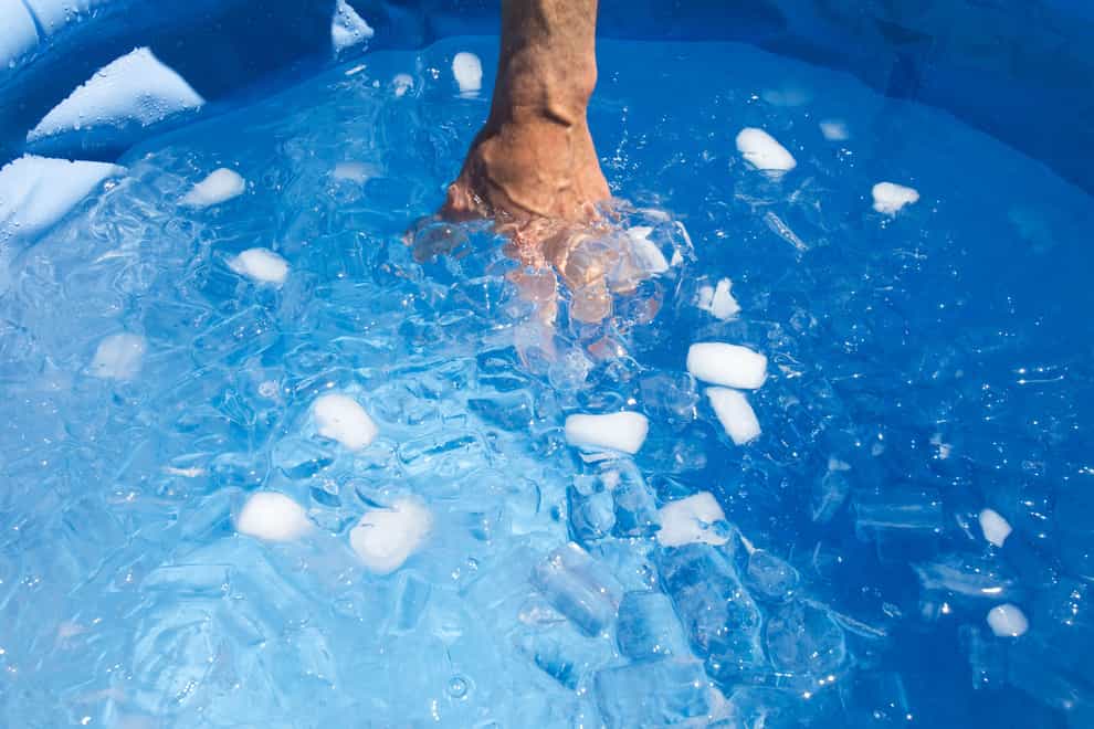 Hand inside ice bath in swimming pool (Alamy/PA)
