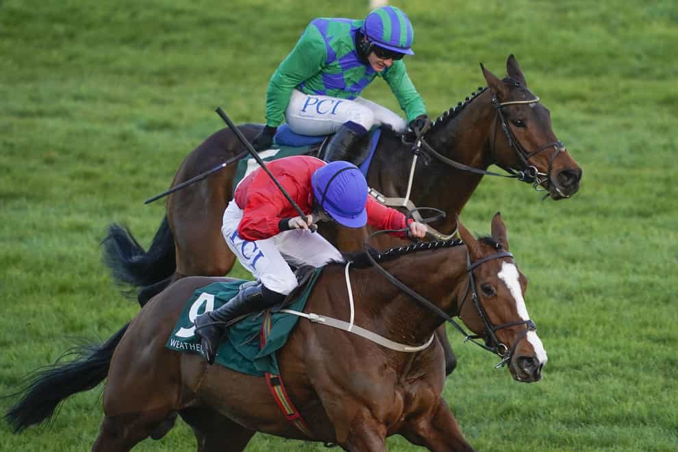 Rachael Blackmore riding Sir Gerhard (red) on the way to winning The Weatherbys Champion Bumper from Paul Townend and Kilcruit (green) during day two of the Cheltenham Festival at Cheltenham Racecourse. Picture date: Wednesday March 17, 2021.