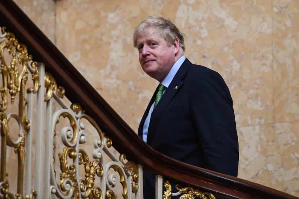 Prime Minister Boris Johnson reacts as he walks up the stairs after a family photo of the leaders of the the Joint Expeditionary Force (JEF), a coalition of 10 states focused on security in northern Europe, following their meeting at Lancaster House in London. Picture date: Tuesday March 15, 2022.