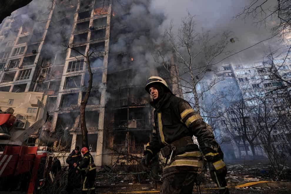 A firefighter walks outside a destroyed apartment building after a bombing in a residential area in Kyiv, Ukraine, Tuesday, March 15, 2022. Russia’s offensive in Ukraine has edged closer to central Kyiv with a series of strikes hitting a residential neighborhood as the leaders of three European Union member countries planned a visit to Ukraine’s embattled capital. (AP Photo/Vadim Ghirda)