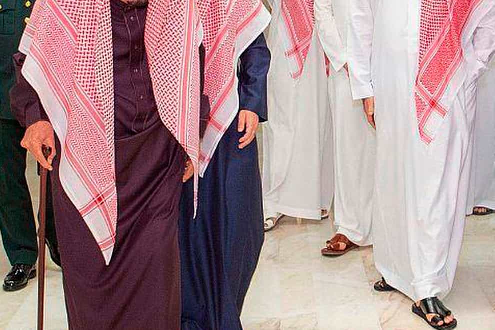 King Salman walks with a cane as he leaves the King Faisal Specialist Hospital in Riyadh with Saudi Crown Prince Mohammed bin Salman, right, and his entourage (Saudi Press Agency/AP)