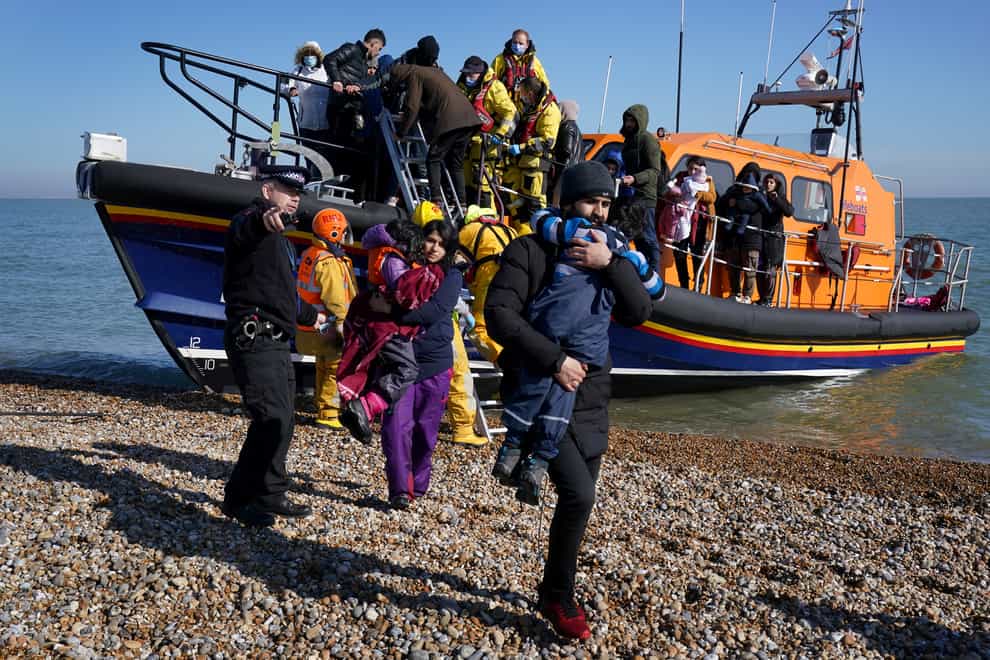 A group of people including young children are brought in to Dungeness, Kent, by the RNLI (Gareth Fuller/PA)