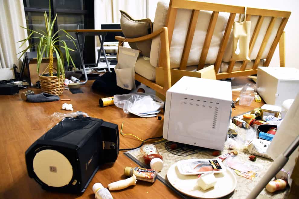 Furniture and electrical appliance lie scattered at an apartment in Fukushima after the earthquake (Kyodo News via AP)