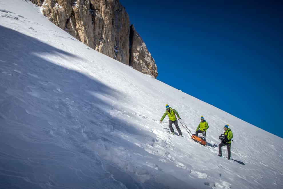 Scientists haul an ice scanner on the slopes of the Mt Gran Sasso d’Italia in central Italy (Riccardo Selvatico/CNR and Ca Foscari University via AP)