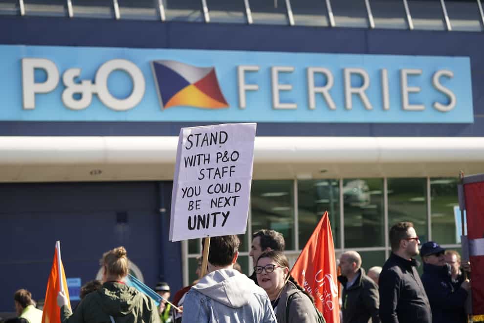 Protesters stand outside the P&O building at the Port of Hull, East Yorkshire, after P&O Ferries suspended sailings and handed 800 seafarers immediate severance notices (Danny Lawson/PA)