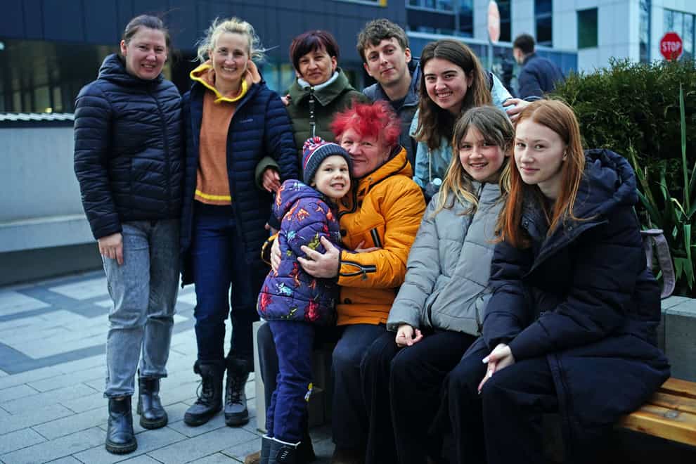 Anastasia Marunich (second right, grey jacket) has had her visa application ‘terminated’ for unknown reasons, her family has said. She is pictured with them at the visa centre in Rzeszow (Victoria Jones/PA)