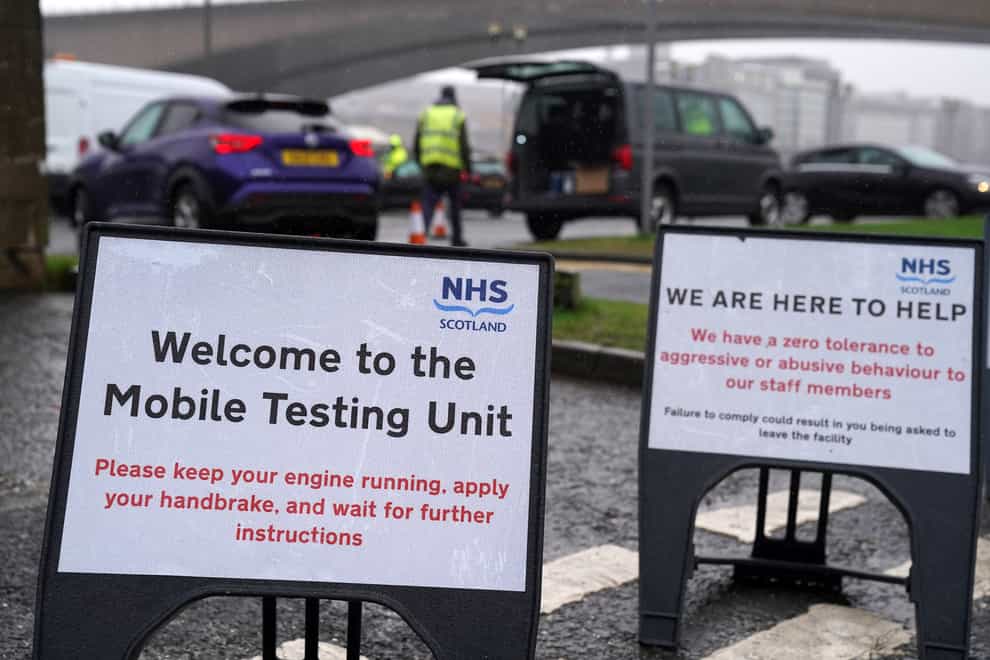 Signs at a mobile Covid-19 test site in Glasgow (Andrew Milligan/PA)
