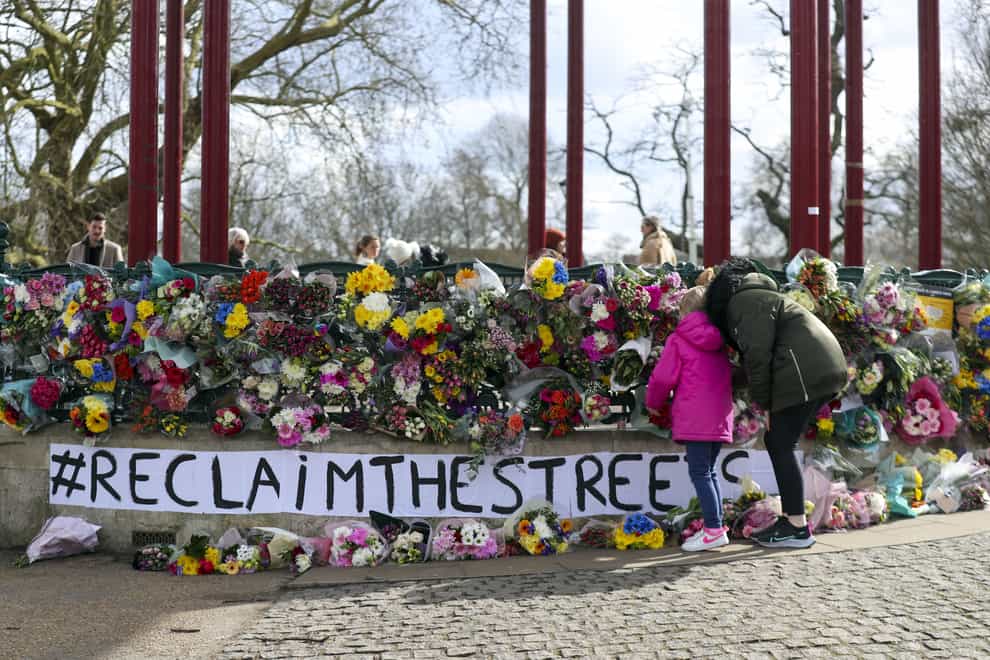 People leave floral tributes at the band stand in Clapham Common (Steve Parsons/PA)
