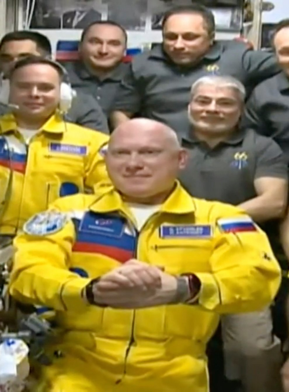 Three Russian cosmonauts have arrived at the International Space Station (ISS) wearing flight suits in yellow and blue colours that match the Ukrainian flag (Roscosmos/AP)