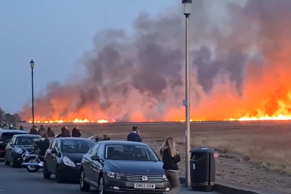 A suspected deliberately started blaze on marshland on the Wirral (@ilovetolift13/PA)