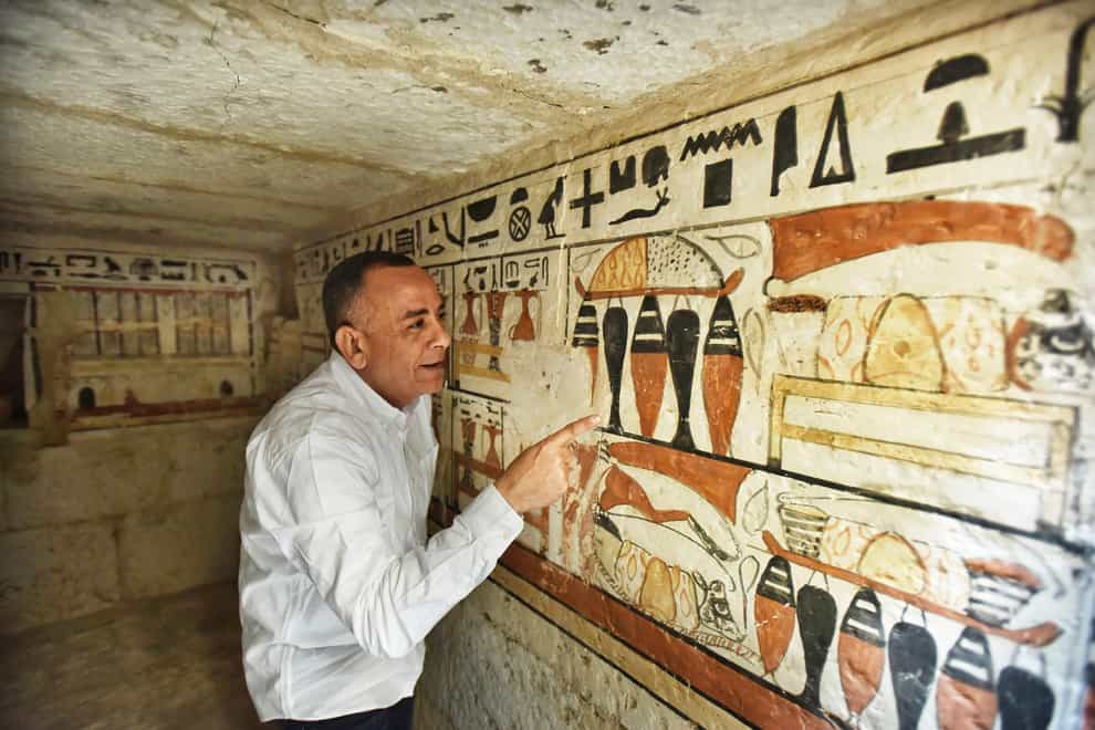 Mostafa Waziri views hieroglyphics inside one of the recently discovered tombs (AP Photo/Sayed Hassan)