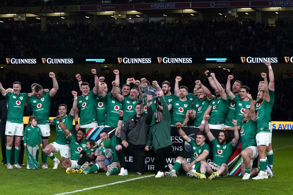 Ireland celebrate with the Triple Crown trophy following their win over Scotland (Brian Lawless/PA)