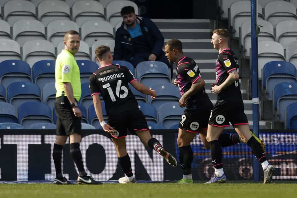 Peterborough’s Jonson Clarke-Harris celebrates scoring his side’s second goal in the win at QPR (PA)