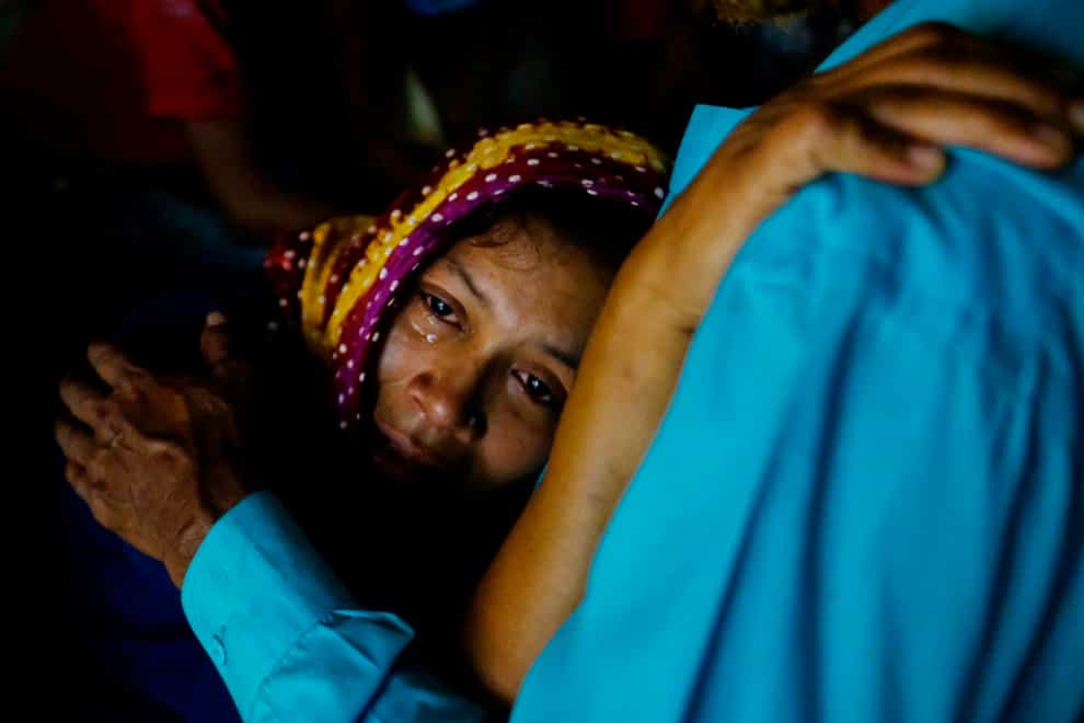 A relative mourns as rescuers try to recover bodies after a cargo vessel hit a ferry carrying dozens of people in Narayanganj, outside Dhaka (Mahmud Hossain Opu/AP)