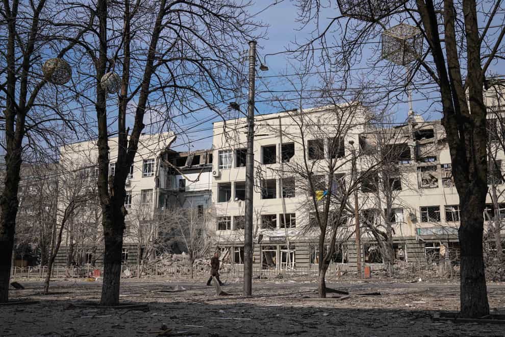 A man walks past a building that was damaged by shelling in Mira Avenue (Avenue of Peace) in Mariupol, Ukraine (Evgeniy Maloletka/AP)