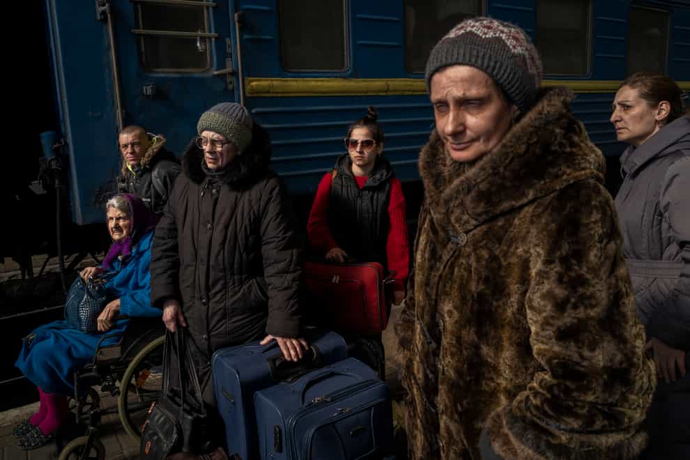 Ukrainians escaping from the besieged city of Mariupol along with other passengers from Zaporizhzhia arrive at Lviv, western Ukraine (Bernat Armangue/AP)