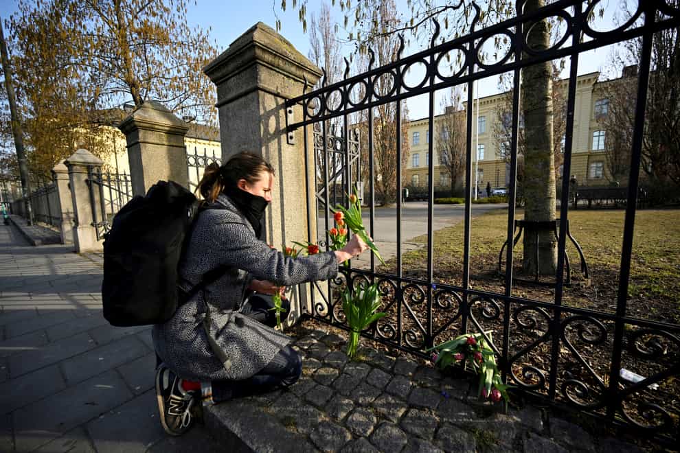 Floral tributes are left outside Malmo Latin School (TT News Agency via AP)