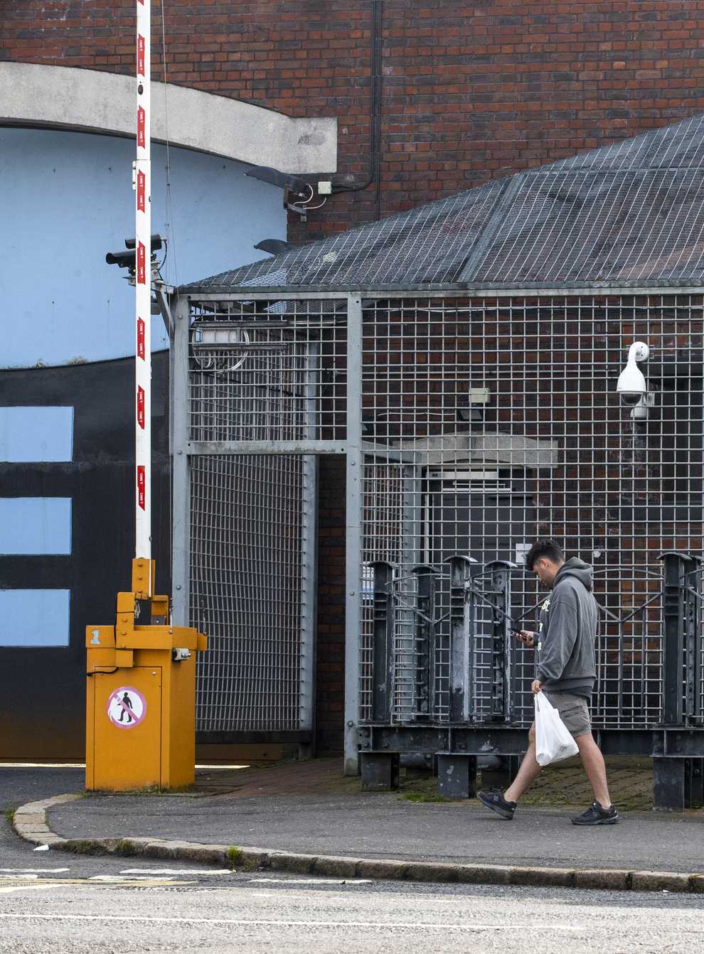 A man walks past Lisburn Road Police Station in south Belfast, as the terrorism threat level in Northern Ireland has been lowered from severe to substantial for the first time in 12 years, Secretary of State Brandon Lewis announced (Liam McBurney/PA)