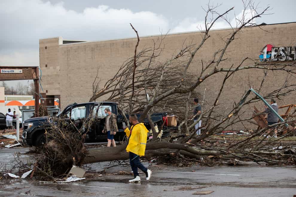 People look at the damage after a tornado hit a shopping center near I-35 and SH 45 in Round Rock, Texas, on Monday, March 21, 2022. (Jay Janner/Austin American-Statesman via AP)