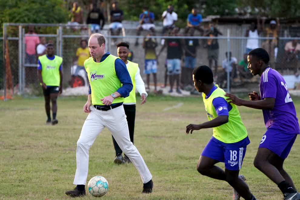 The Duke of Cambridge joins young footballers on the pitch during a visit to Kingston, Jamaica, on day four of their Caribbean tour (Jane Barlow/PA