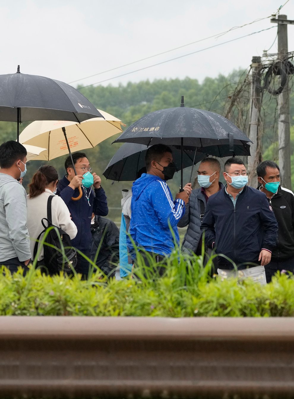 Relatives of passengers onboard the China Eastern Flight 5735 arrive near the crash site on Wednesday March 23 2022 in Lu village (Ng Han Guan/AP)