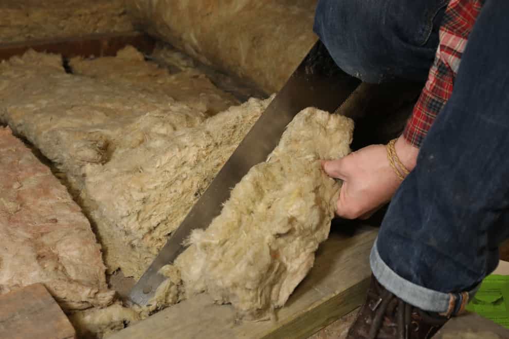 Installing loft insulation (Philip Toscano/PA)