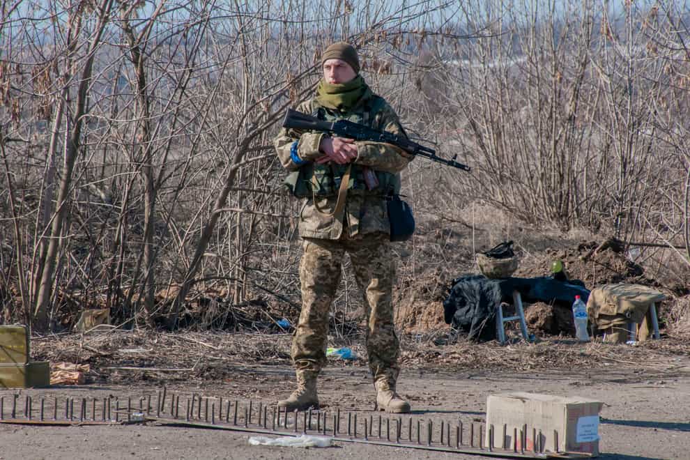 A Ukrainian serviceman guards his position in Kharkiv (Andrew Marienko/AP)