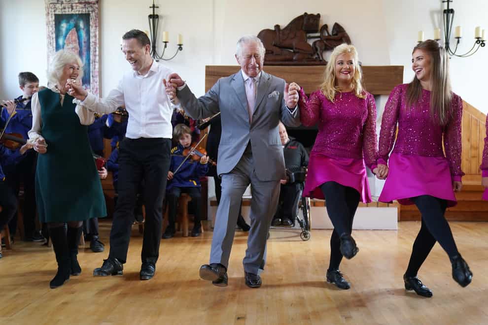 The Prince of Wales and the Duchess of Cornwall are shown the steps of a traditional Irish dance at the Bru Boru Cultural Centre in Cashel, Co Tipperary (Brian Lawless/PA)