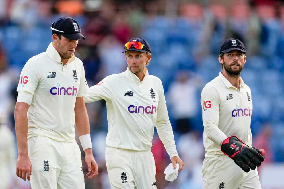 England’s captain Joe Root, centre, leaves the field with teammates Craig Overton, left, and Ben Foakes at the end of day two of their third Test cricket match against West Indies at the National Cricket Stadium in Grenada (AP Photo/Ricardo Mazalan)