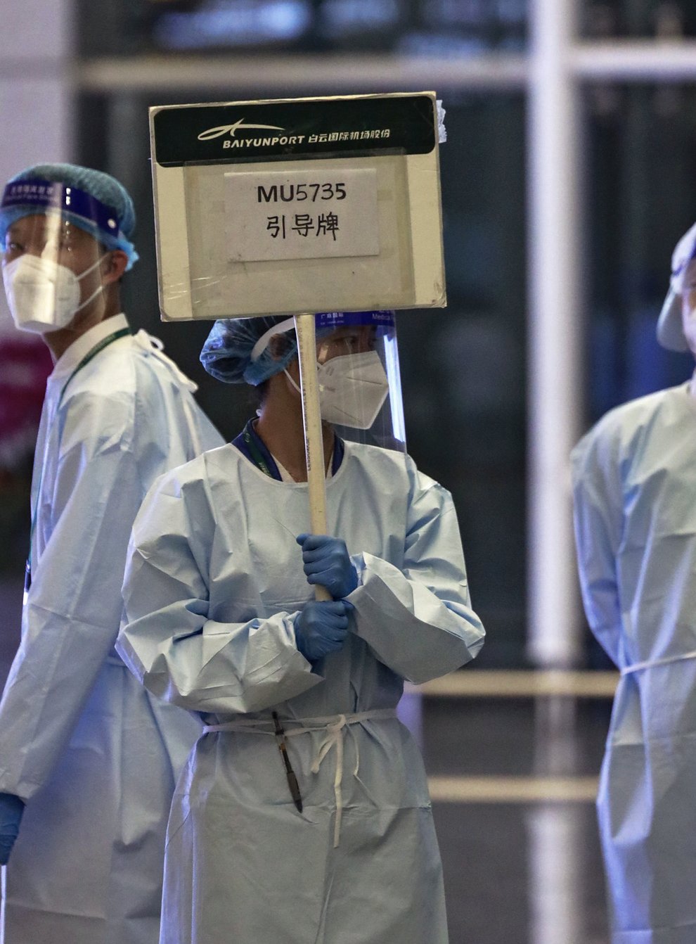 A worker holds a signboard waiting to lead relatives of the victims aboard China Eastern’s flight MU5735 (Chinatopix/AP)